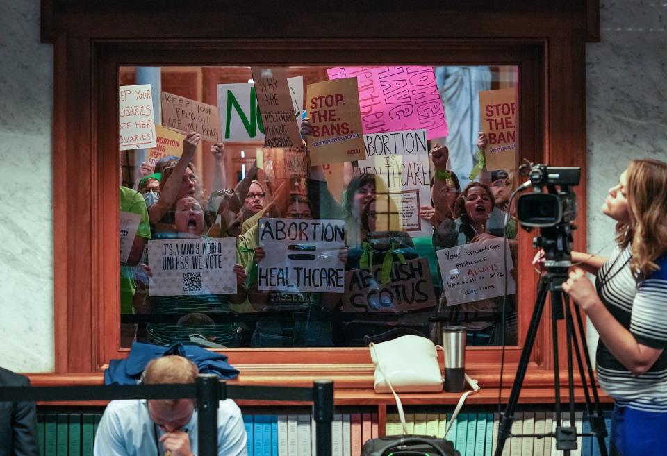 Demonstrators protest outside the Senate chambers before the start of special session Saturday, July 30, 2022, at the Indiana Statehouse in Indianapolis. 