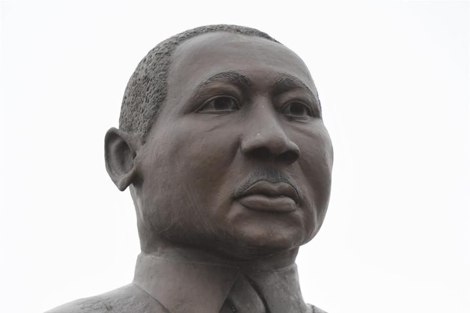 A statue of Martin Luther King Jr., depicting him alongside 14-year-old lynching victim Emmett Till, sits next to the former Lincoln Home on North Grand Avenue.