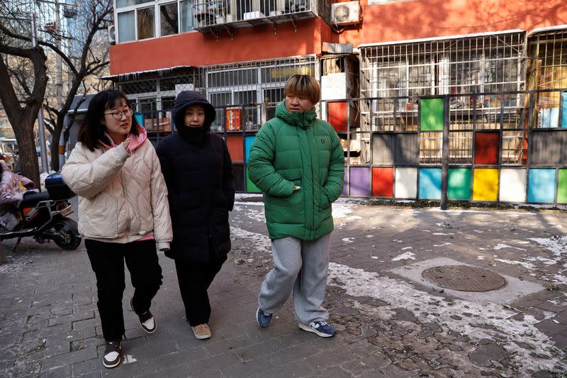 People walk on a street on a cold winter day in Beijing