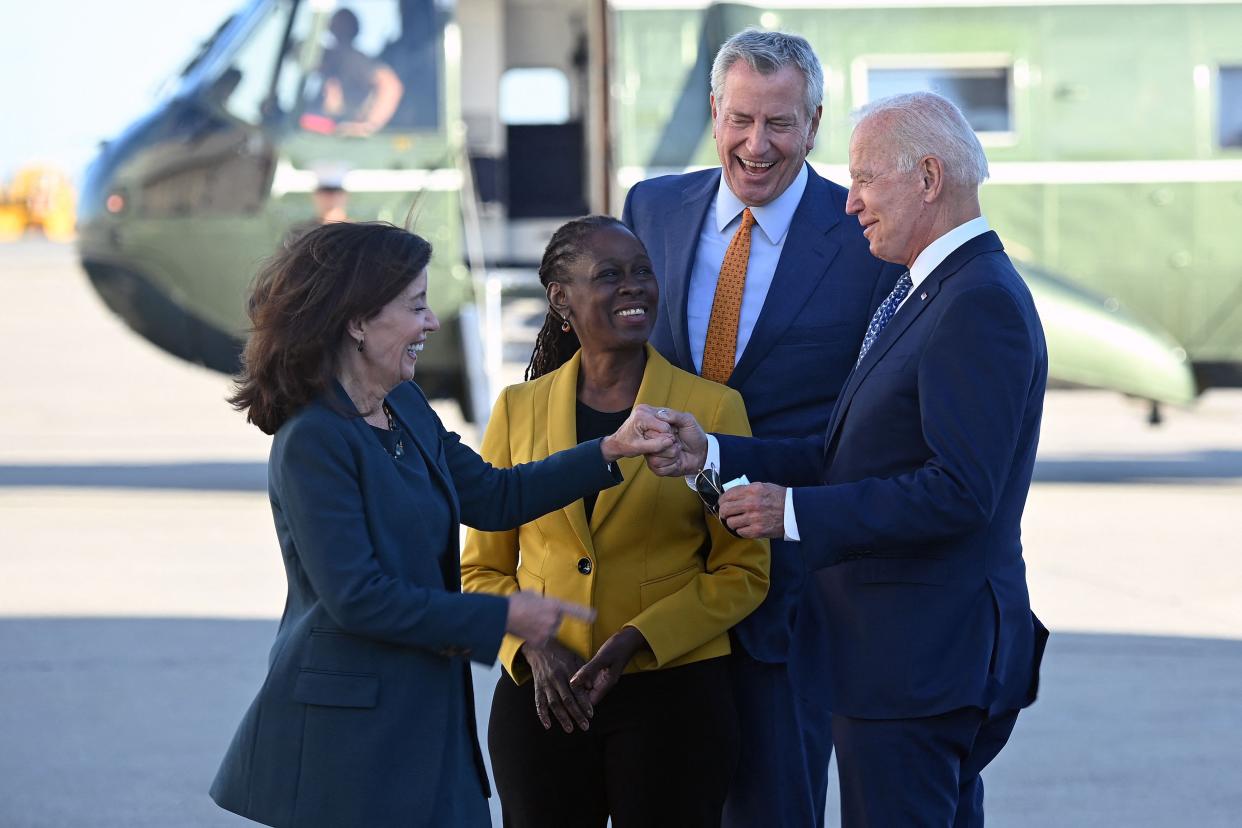 President Joe Biden (R) greets New York City's Mayor Bill de Balsio (2nd R), his wife Chirlane McCray (C) and New York Governor Kathy Hochul (L) upon arrival at John F. Kennedy International Airport in New York on September 20. 