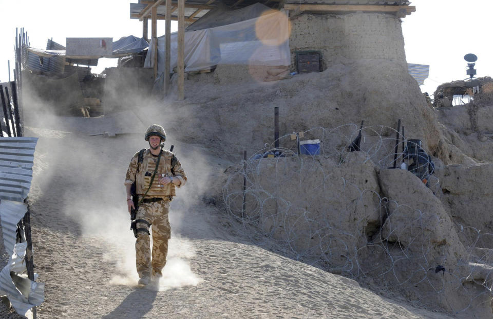 FILE - Britain's Prince Harry on patrol through the deserted town of Garmisir Jan. 2, 2008, close to FOB (forward operating base) Delhi, where he was posted in Helmand province Southern Afghanistan. Prince Harry alleges in a much-anticipated new memoir that his brother Prince William lashed out and physically attacked him during a furious argument over the brothers’ deteriorating relationship. The book “Spare" also included incendiary revelations about the estranged royal’s drug-taking, first sexual encounter and role in killing people during his military service in Afghanistan. (John Stillwell, Pool Photo via AP, File)