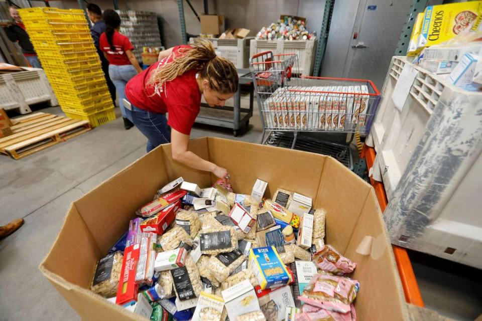 San Luis Obispo resident Linda Gonzalez, Bank of America financial solutions advisor, checks a box filled with pasta and noodles at the SLO Food Bank’s 20,000-square-foot San Luis Obispo warehouse. The food bank is seeking monetary donations.