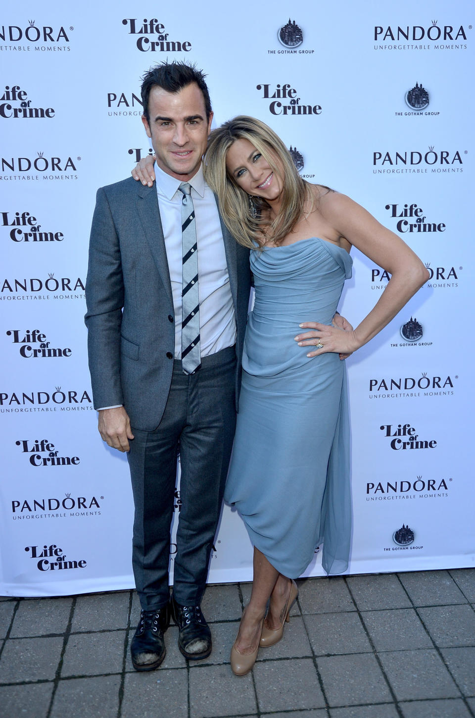 Actress/Producer Jennifer Aniston (wearing Vivienne Westwood gown) and actor Justin Theroux attend the 'Life of Crime' cocktail reception presented by PANDORA Jewelry at Hudson Kitchen during the 2013 Toronto International Film Festival on September 14, 2013 in Toronto, Canada.