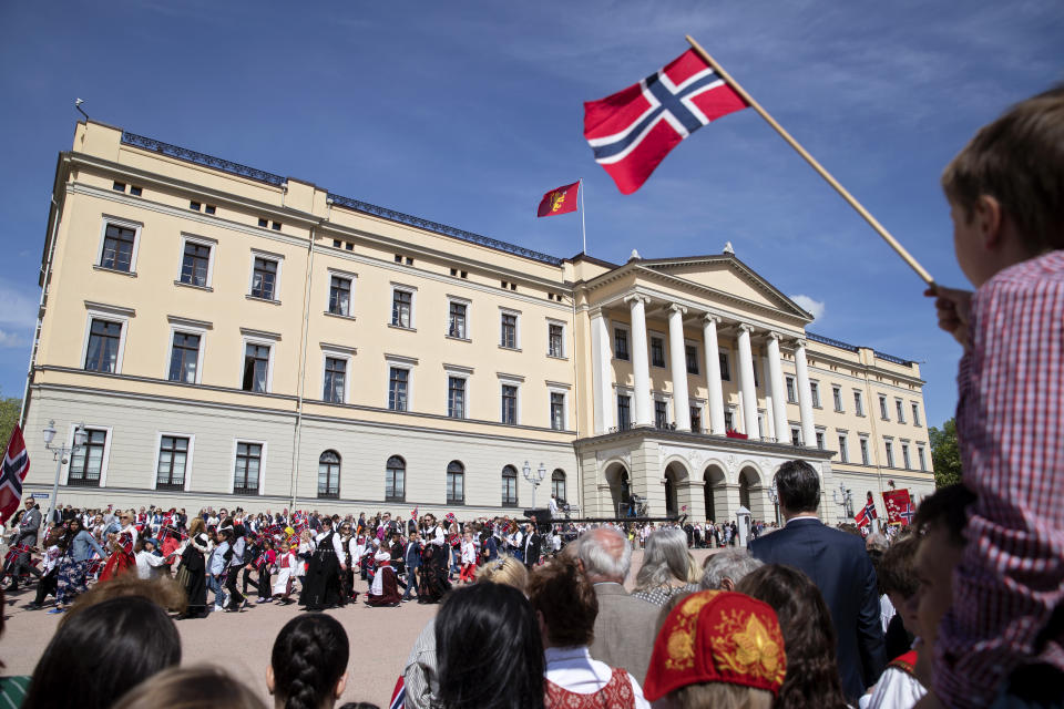 FILE - Local schoolchildren march past the Royal Palace during a parade in Oslo, Norway to celebrate Norwegian Constitution Day on Friday May 17, 2019. Norway's adoption authority is recommending a halt to all foreign adoptions of children for a two-year period pending an investigation into several allegedly illegal cases. (Ryan M. Kelly/NTB Scanpix via AP, File)