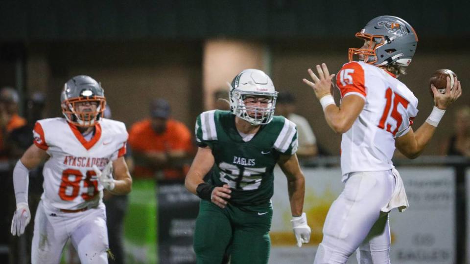 Kane cooks passes under pressure from Kohen Sizemore, Cole Loney is at left. Templeton lead for most of the game but at the end Atascadero came up with the win 20-16 Oct. 6, 2023.