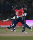 England's Harry Brook, right, and Alex Hales run between the wickets to score during the first T20 cricket match between Pakistan and England, in Karachi, Pakistan, Tuesday, Sept. 20, 2022. (AP Photo/Anjum Naveed)