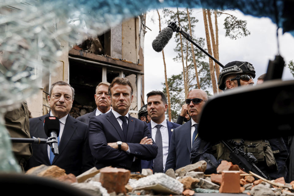 Italian Prime Minister Mario Draghi, left, and French President Emmanuel Macron watch debris as they visit Irpin, outside Kyiv, Thursday, June 16, 2022. The leaders of France, Germany, Italy and Romania arrived in Kyiv on Thursday in a show of collective European support for the Ukrainian people as they resist Russia's invasion, marking the highest-profile visit to Ukraine's capital since Russia invaded its neighbor. (Ludovic Marin, Pool via AP)