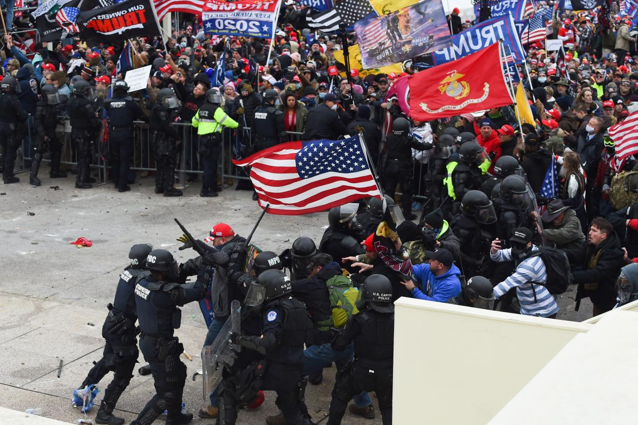 Trump supporters clash with police and security forces as they storm the US Capitol in Washington D.C on January 6, 2021.