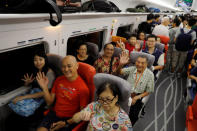 Passengers react on a first train departing from Hong Kong during the first day of service of the Hong Kong Section of the Guangzhou-Shenzhen-Hong Kong Express Rail Link, in Hong Kong, China September 23, 2018. REUTERS/Tyrone Siu