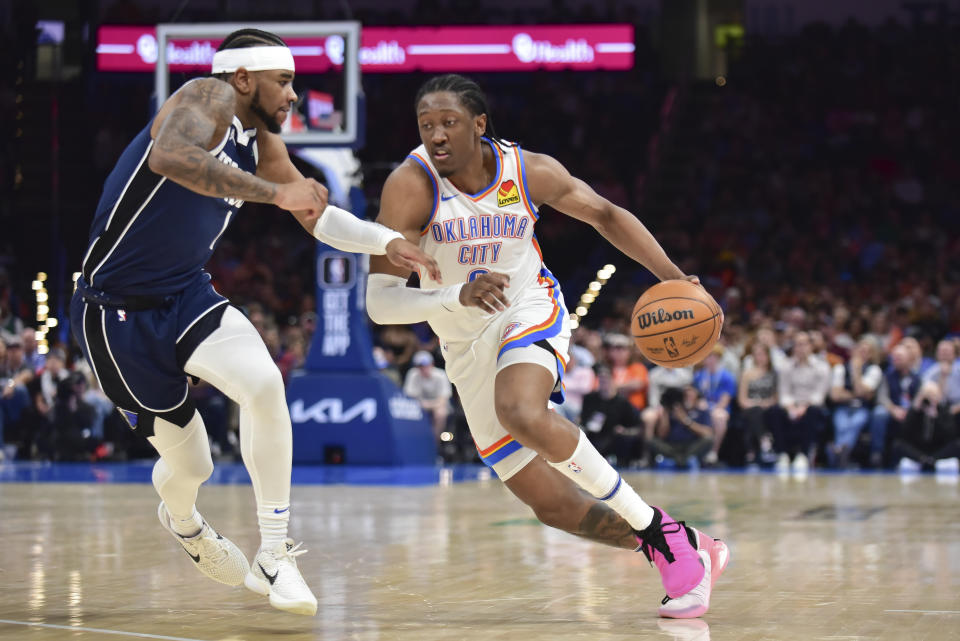 Oklahoma City Thunder forward Jalen Williams, right, drives against Dallas Mavericks guard Jaden Hardy during the second half of an NBA basketball game Thursday, March 14, 2024, in Oklahoma City. (AP Photo/Kyle Phillips)