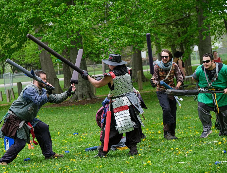 Members of the Ashen Hills community clash with foam weapons and engage in a role-playing fantasy game called Amtgard every Sunday in Patriarche Park in East Lansing Sunday, May 15, 2022. The community is about 30 to 35 members strong and is open to newcomers who want to try it out. All of the medieval costumes and weapons are handmade and inspected before every game.