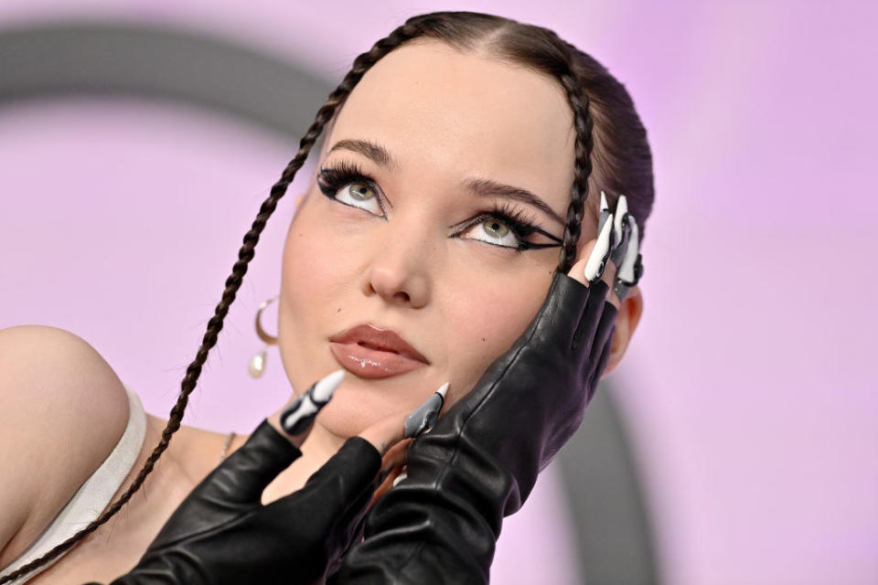 closeup of dove with two braids at the front of her face and long nails