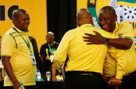 Deputy president of South Cyril Ramaphosa (R) embraces President of South Africa Jacob Zuma during the 54th National Conference of the ruling African National Congress (ANC) at the Nasrec Expo Centre in Johannesburg, South Africa December 16, 2017. REUTERS/Siphiwe Sibeko