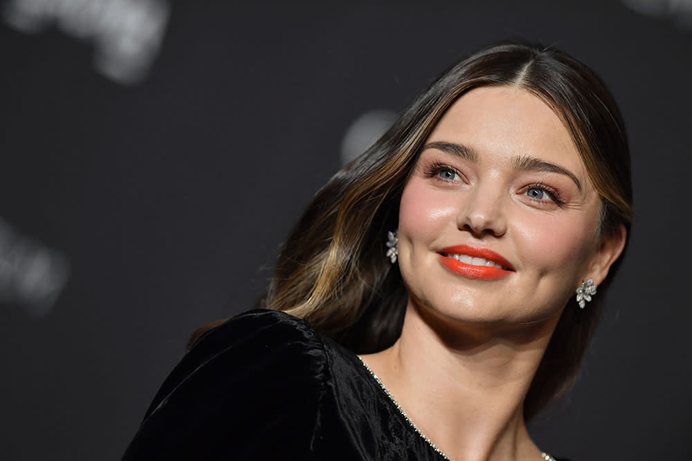 Miranda Kerr in a black top and red lipstick