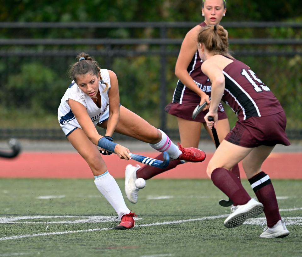 Emily Layton of Monomoy fires a shot defended by Jane Hostetter of Falmouth.