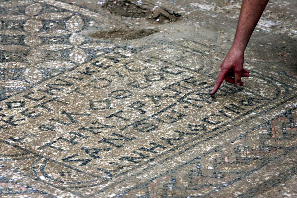 An Israeli archaeologist points at a nearly 1,800-year-old decorated floor from an early Christian prayer hall that Israeli archaeologists discovered on Sunday, Nov. 6, 2005, in the Megiddo prison. Israeli officials are considering uprooting the mosaic and loaning it to the controversial Museum of the Bible in Washington D.C., a proposal that has upset archaeologists and underscores the hardline government’s close ties with evangelical Christians in the U.S. | Ariel Schalit, Associated Press