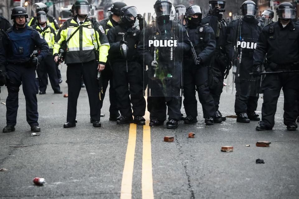 Bricks thrown by protestors rest at the feet of police officers during a demonstration after the inauguration of President Donald Trump, Friday, Jan. 20, 2017, in Washington. (AP Photo/John Minchillo)