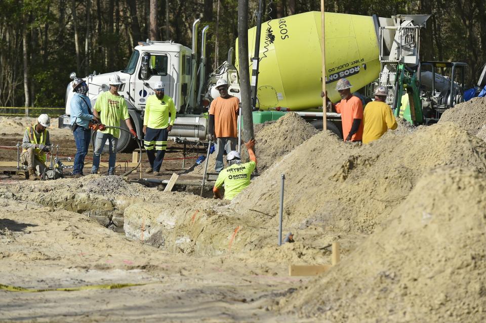 A construction crew prepares the site for the University of North Florida's new Hicks Honors College residence hall, scheduled to open in fall 2025. Addition of the 521-bed project is part of UNF's plan to grow enrollment by 8,000 students to 25,000 in 2028.