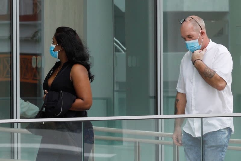 Briton Skea Nigel and partner Agatha Maghesh Eyamalai arrive at the State Courts in Singapore