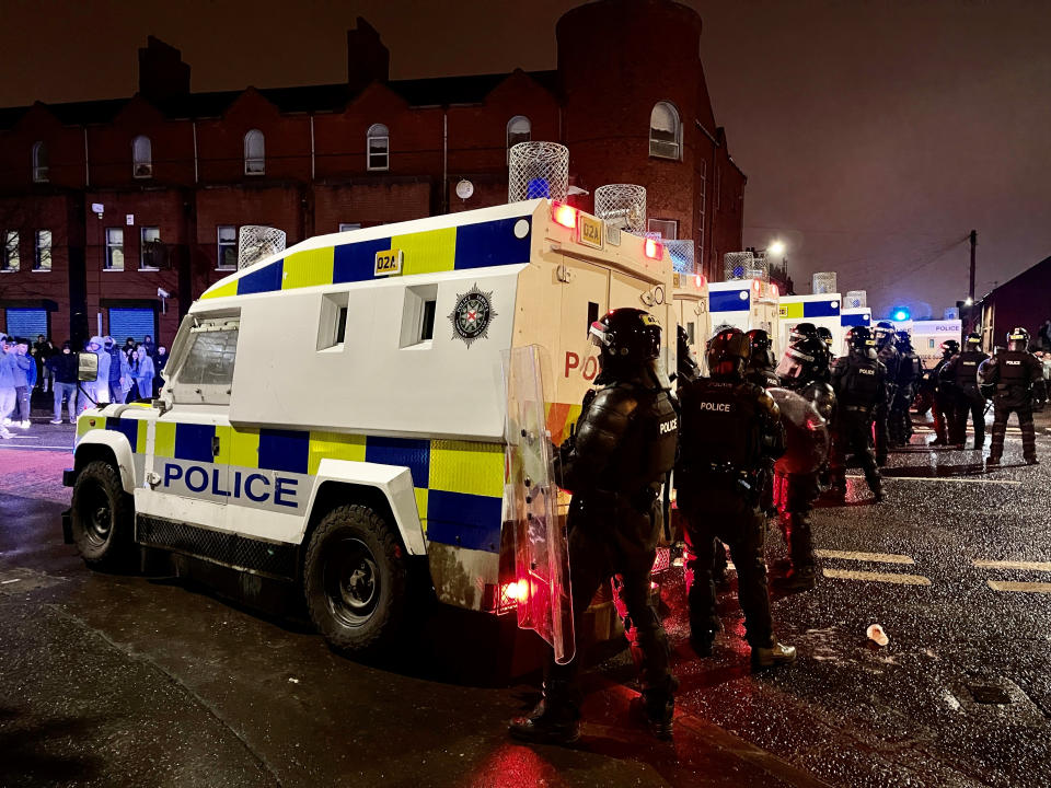 PSNI officers and Land Rovers on the nationalist side of the Springfield Road in Belfast after dispersing people from the area, following further unrest. Picture date: Wednesday April 7, 2021.
