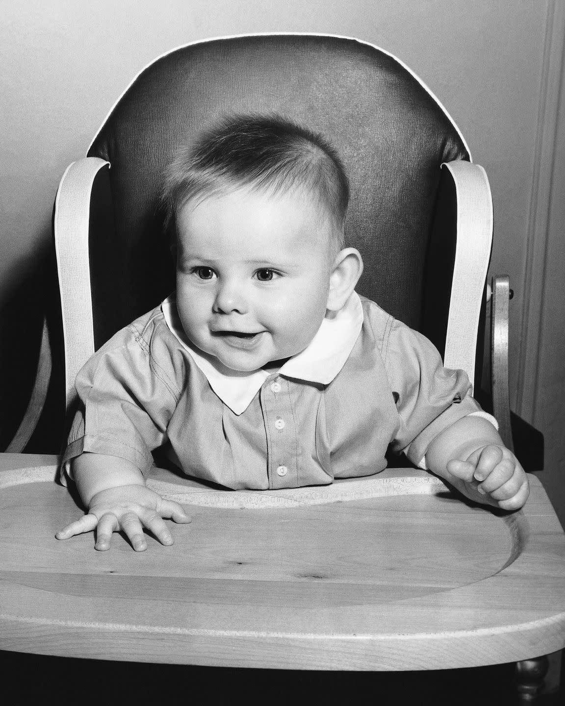 baby sitting in high chair