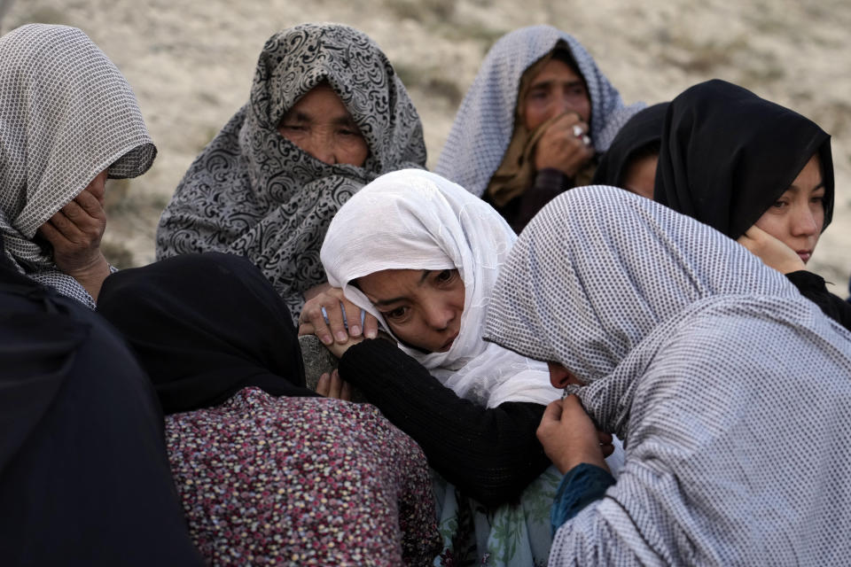 The family of 20-year-old Vahida Heydari, who was a victim of a suicide bombing on a Hazara education center, mourns over her grave, in Kabul, Afghanistan, Sunday, Oct. 2, 2022. Last week’s suicide bombing at the Kabul education center killed as many as 52 people, more than double the death toll acknowledged by Taliban officials, according to a tally compiled by The Associated Press on Monday. (AP Photo/Ebrahim Noroozi)