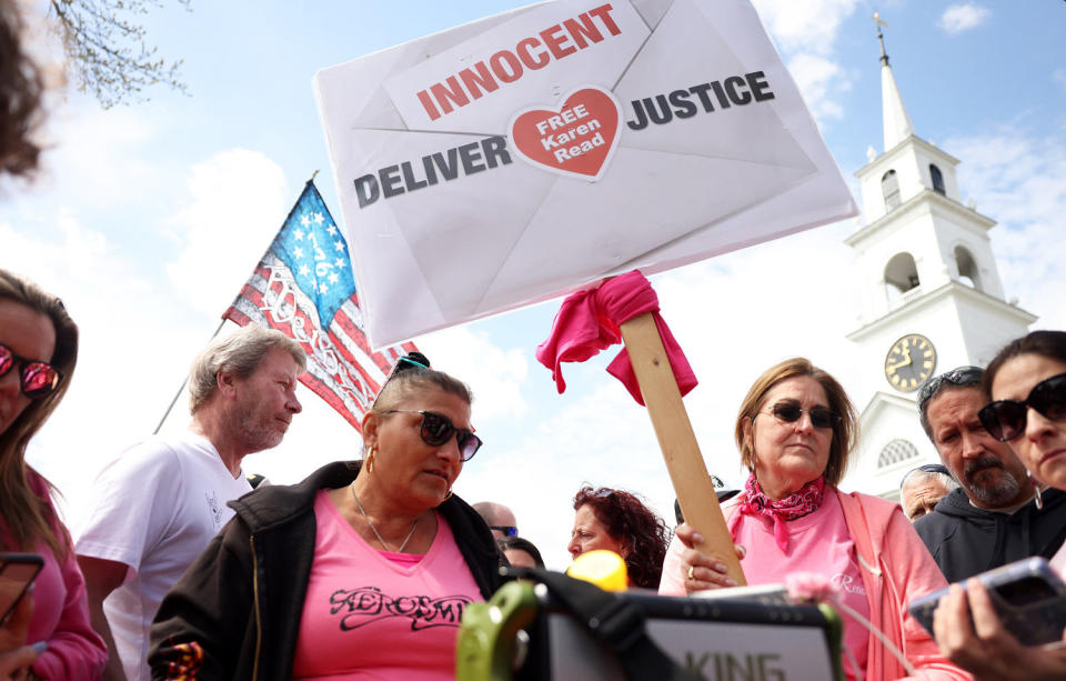 Karen Read supporters gathered around a phone speaker to listen to opening arguments (Jessica Rinaldi / The Boston Globe  / Getty Images)