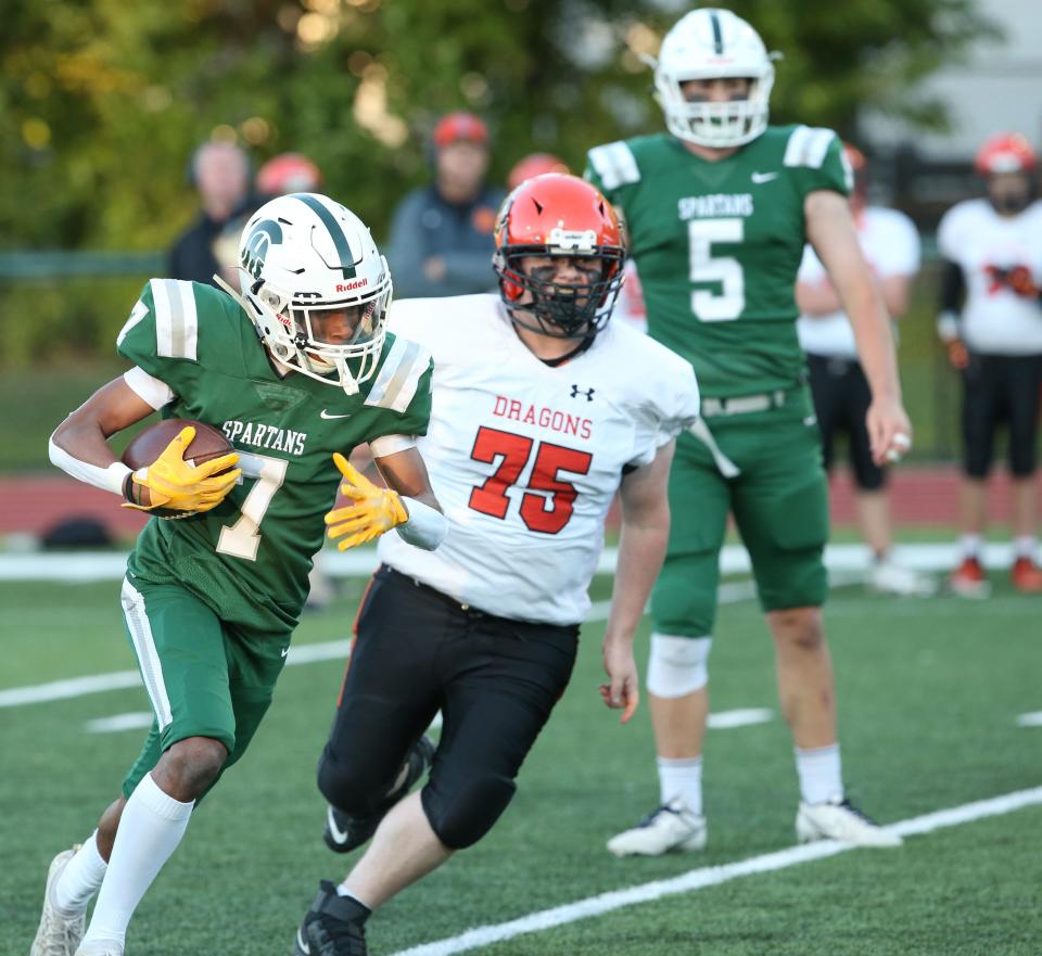 Spackenkill's Josh Lewis carries the ball while chased by Dover's Danny Duncan during a Sept. 23, 2022 football game.