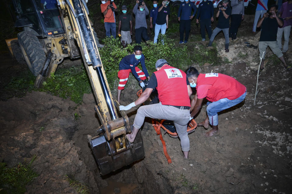 Rescuers bury the body of a Rohingya refugee recovered from the sea in Meulaboh, Indonesia, on Sunday, March 24, 2024. The bodies of 12 women and three children were recovered following the capsize of a boat that was carrying around 140 Rohingya refugees, according to the United Nations High Commissioner for Refugees. Sixty-seven people were killed in the disaster. (AP Photo/Reza Saifullah)