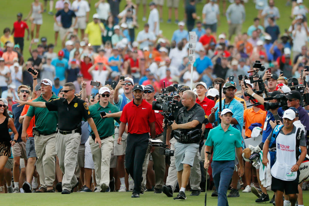 Tiger Woods (center, in red) and the stampede. (Getty)