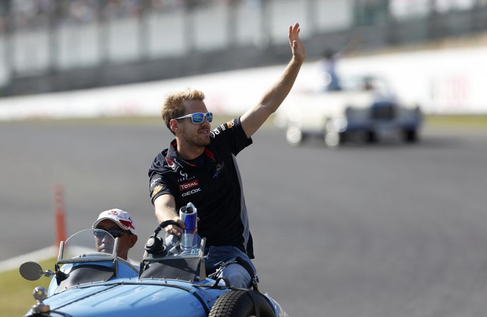 Red Bull Formula One driver Sebastian Vettel of Germany waves during the drivers' parade before the Japanese F1 Grand Prix at the Suzuka circuit October 13, 2013. REUTERS/Toru Hanai (JAPAN - Tags: SPORT MOTORSPORT F1)