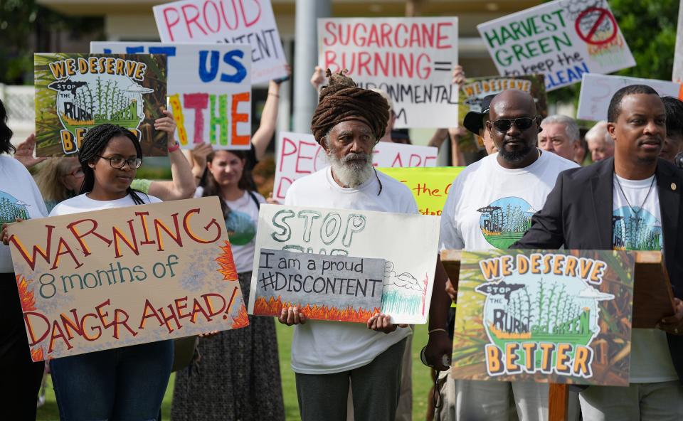 People participate in a protest in downtown West Palm Beach, across from Florida Crystals' corporate headquarters, to protest the start of another sugarcane burn season. The purpose of the protest was to draw attention to life-threatening harms caused by pre-harvest sugar field burning in Florida. Saturday, Oct. 1, 2022 in West Palm Beach. 