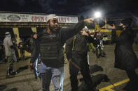 People gather during a counter protest against Black Lives Matter in Vancouver, Wash., Friday, Oct. 30, 2020, after a candlelight vigil for Kevin Peterson Jr., who was killed in Thursday's shooting with police involved. The Clark County Sheriff's office has not released any details on the Thursday evening shooting in Hazel Dell, but a man told The Oregonian/OregonLive that his 21-year-old son was fatally shot by police. (AP Photo/Paula Bronstein)