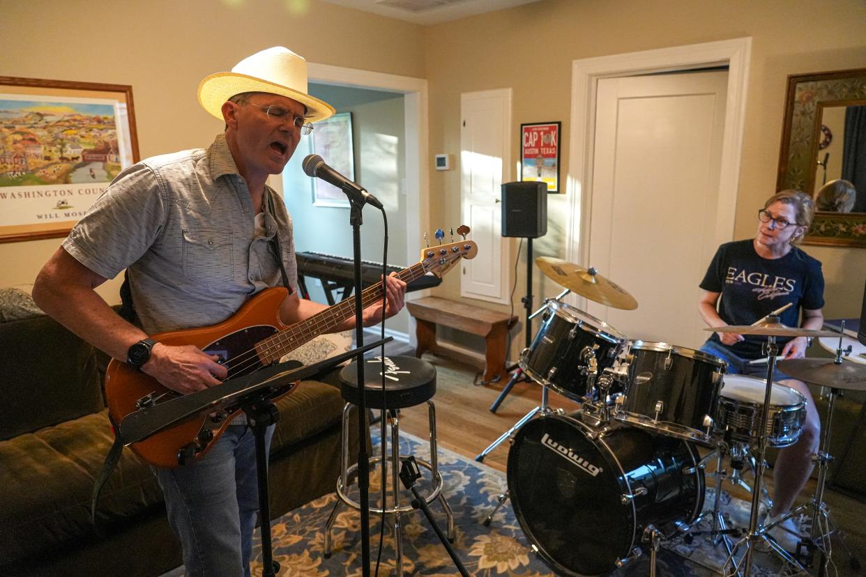 Allan Cole, left, and Adrian Loucks, right, practice in a space behind Cole's Austin home on April 28. Cole was diagnosed with Parkinson's disease about eight years ago and began playing bass guitar in February 2023.