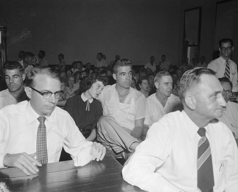 (Original Caption) Mrs. Bryant Gives “Wolf Whistle” Account. Sumner, Mississippi: Carolyn Bryant and her husband, Roy, consult with defense attorney Sidney Carlton at the courthouse in Sumner where Roy and his half brother, J.W. Milam, are on trial for the “wolf whistle” kidnap murder of Emmett Louis Till, 14 year old Chicago Negro. Mrs. Bryant testified today that a Negro man caught her around the waist and asked her for a date - Photo: Bettmann / Contributor (Getty Images)