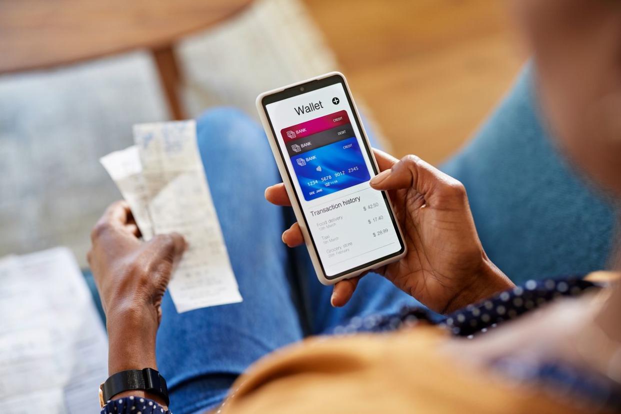 woman using mobile phone to check payments