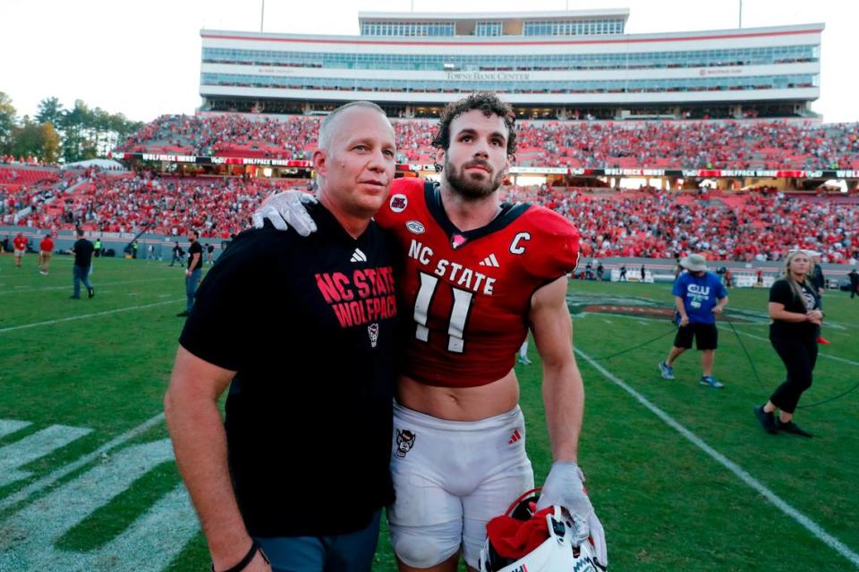 N.C. State head coach Dave Doeren and linebacker Payton Wilson walk off the field after the Wolfpack’s 24-17 victory over Clemson at Carter-Finley Stadium in Raleigh, N.C., Saturday, Oct. 28, 2023. Ethan Hyman/ehyman@newsobserver.com