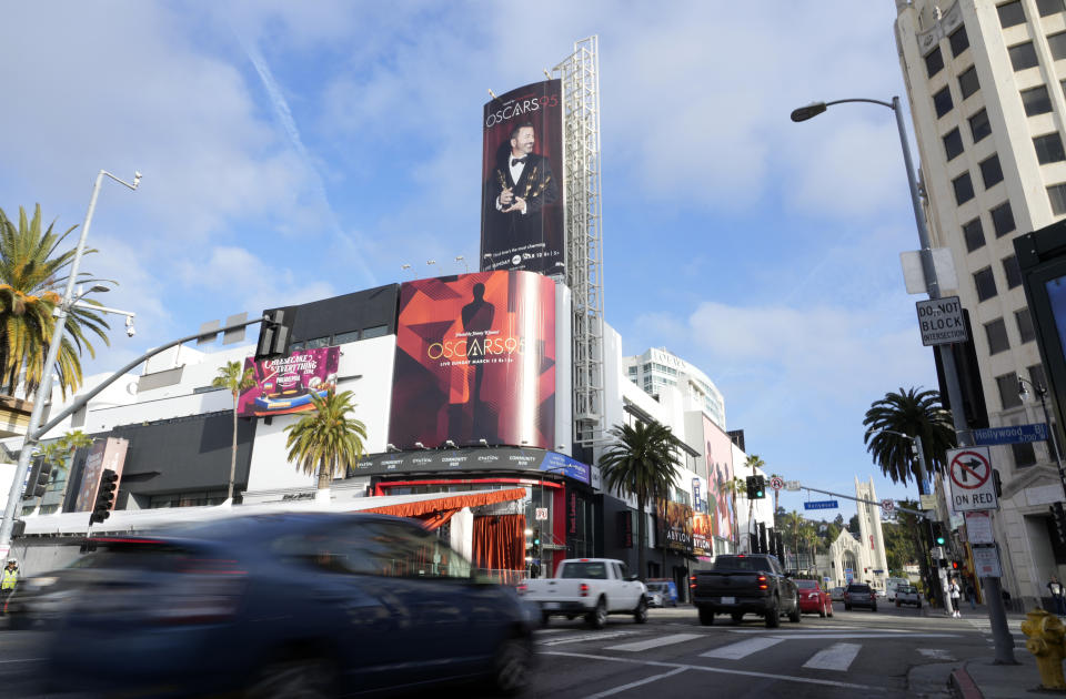 Cars move past an advertisement for Sunday's 95th Academy Awards near the Dolby Theatre, Wednesday, March 8, 2023, in Los Angeles. The 95th Academy Awards will be held at the Dolby Theatre on Sunday. (AP Photo/Chris Pizzello)