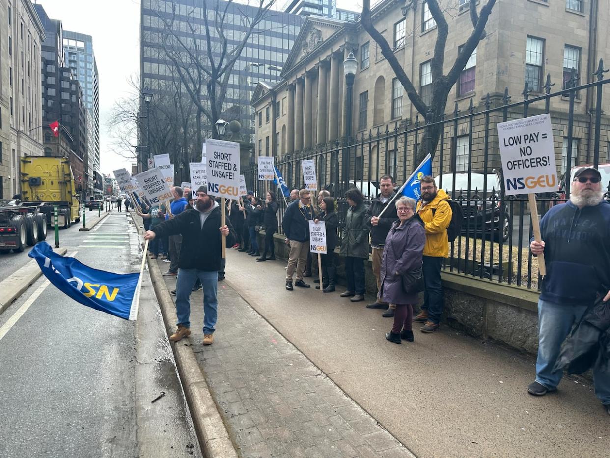 On Wednesday, about 50 members of the union that represents correctional officers converged on the provincial legislature to confront politicians over the issue. (Blair Rhodes/CBC - image credit)