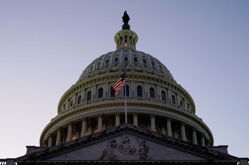 FILE PHOTO: FILE PHOTO: The U.S. Flag lies in front of the U.S. Capitol dome prior to Trump impeachment vote in Washington