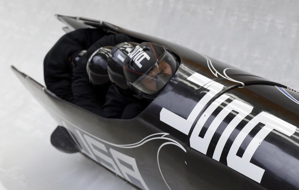 The team from the United States, piloted by Steven Holcomb, take a curve during the men's four-man bobsled training at the 2014 Winter Olympics, Feb. 21, 2014, in Krasnaya Polyana, Russia. 