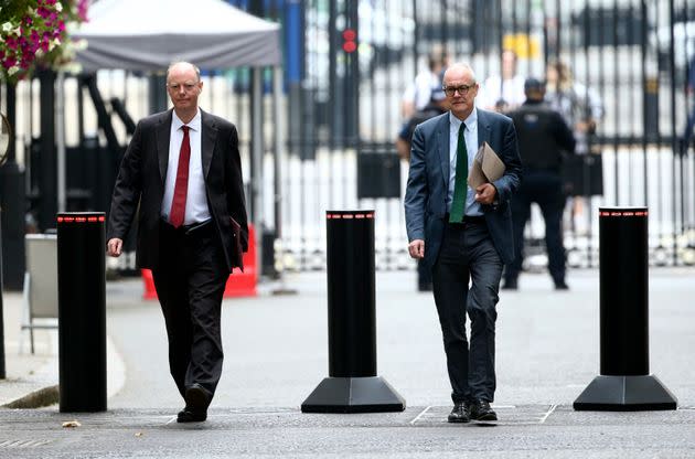 The government's chief medical officer Chris Whitty, left, and chief scientific adviser Patrick Vallance arrive in Downing Street, London, Monday Sept. 21, 2020. 