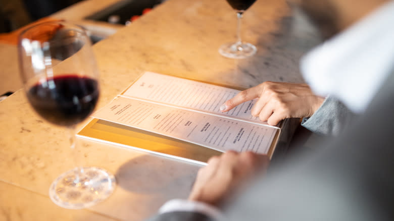 people looking at restaurant menu