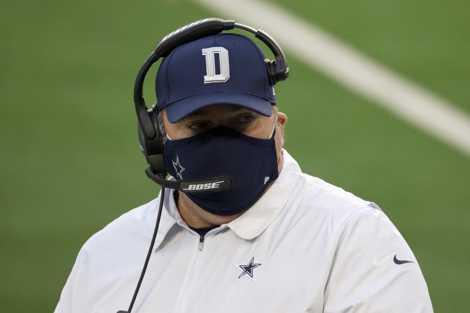 Dallas Cowboys head coach Mike McCarthy talks with a member of his staff on the sideline in the second half of an NFL football game against the San Francisco 49ers in Arlington, Texas, Sunday, Dec. 20, 2020. (AP Photo/Ron Jenkins)