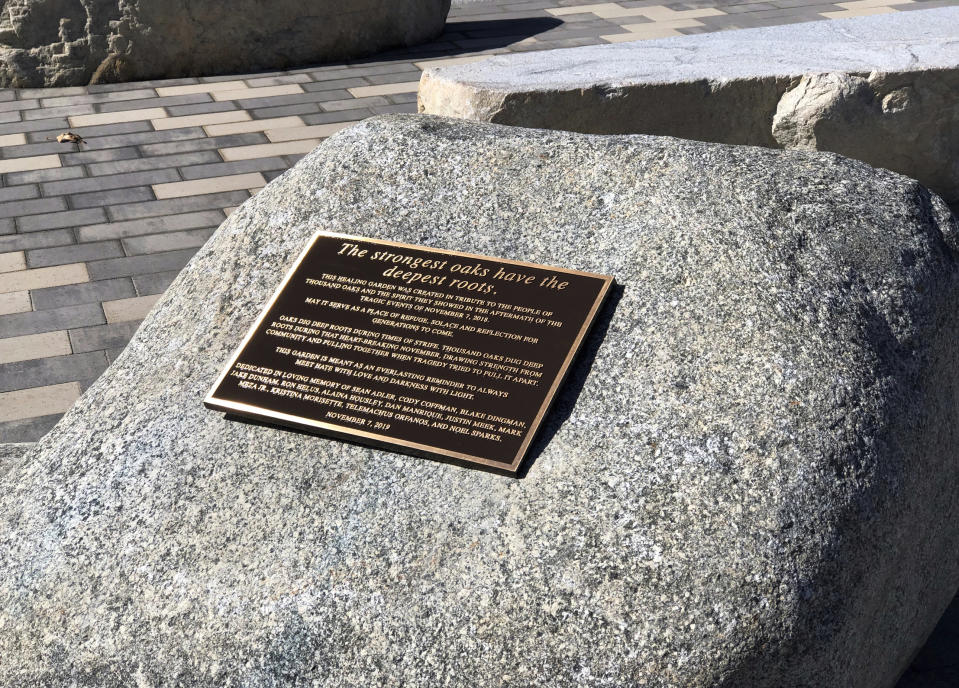 This October 2019 photo shows a plaque on one of several boulders at The Healing Garden, a public park memorial to commemorate the 12 people killed in a mass shooting and gun battle at the Borderline Bar & Grill in Thousand Oaks, Calif., a Southern California country-western bar a year earlier. The garden was dedicated Thursday, Nov. 7, 2019, the anniversary of the shooting. (Andrew Mooney via AP)