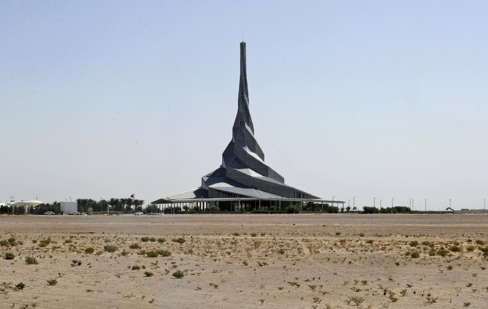 The Solar Innovation Center at the Mohammed bin Rashid Al Maktoum Solar Park marks the skyline about 50 kilometres south of Dubai, United Arab Emirates, Wednesday, Oct. 14, 2020. In the oil-rich UAE, an unusual sight is rising in Dubai -- a coal-fired power plant, a first for the region. The $3.4 billion Hassyan power plant in Dubai appears puzzling as the UAE hosts the headquarters of the International Renewable Energy Agency. (AP Photo/Kamran Jebreili)