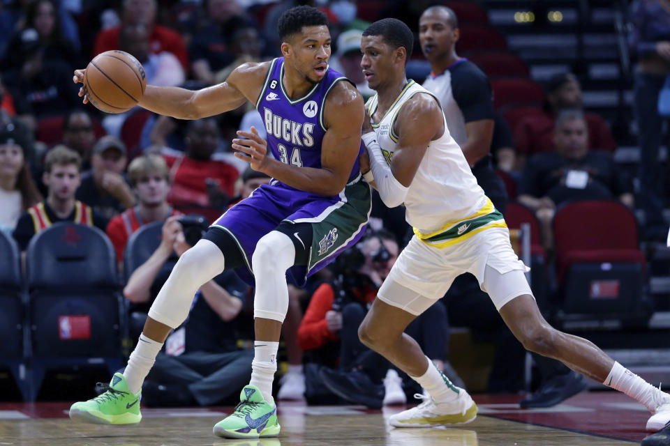 Milwaukee Bucks forward Giannis Antetokounmpo (34) pushes to the basket against Houston Rockets forward Jabari Smith Jr. (1) during the first half of an NBA basketball game Sunday, Dec. 11, 2022, in Houston. (AP Photo/Michael Wyke)