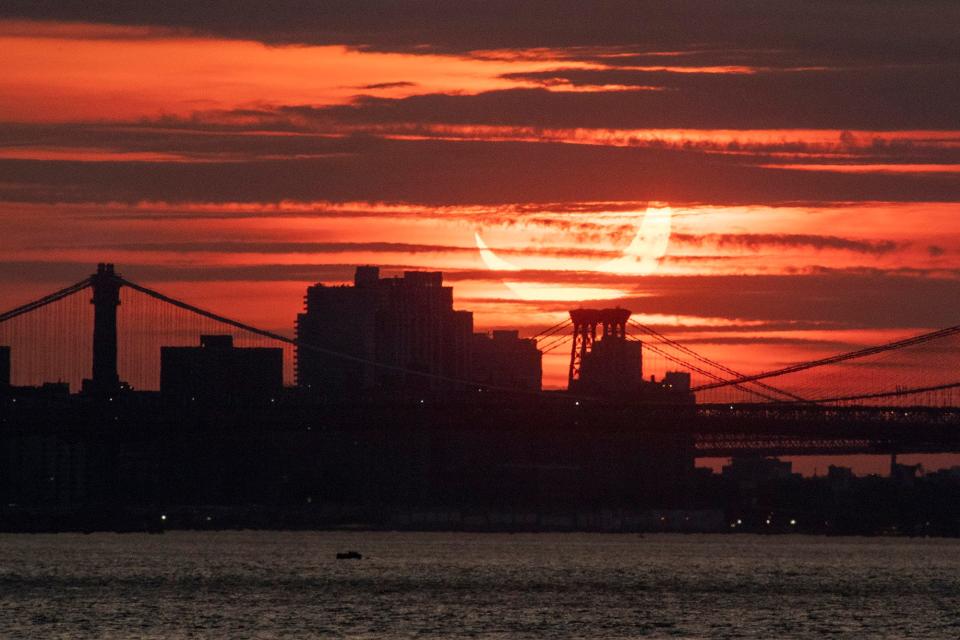 A solar eclipse rises behind the New York City Skyline on June 10, 2021. Approximately 80% of the sun was blocked by the moon.