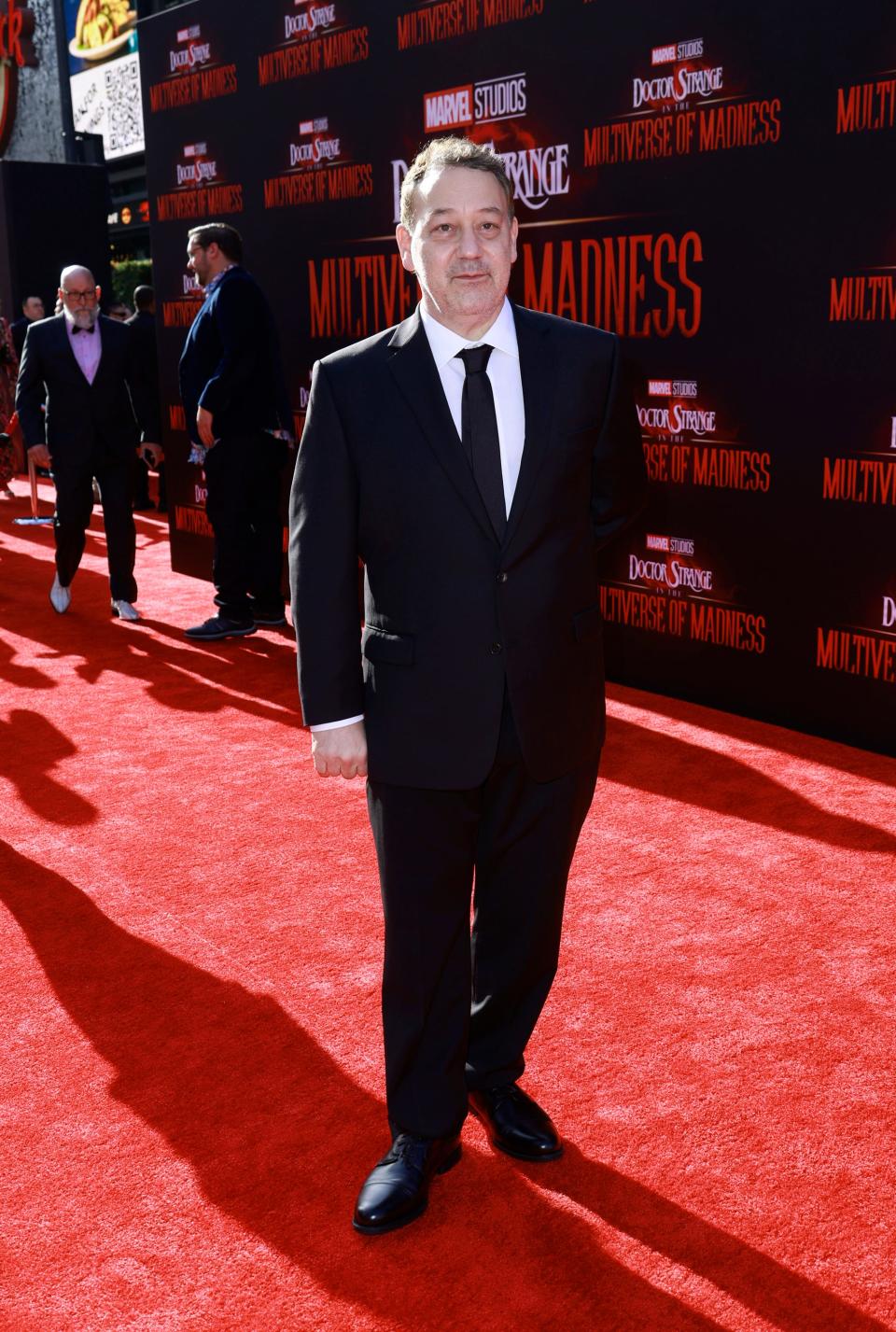 Sam Raimi wearing a black suit and tie at the LA premiere of "Doctor Strange in the Multiverse of Madness" in May 2022.