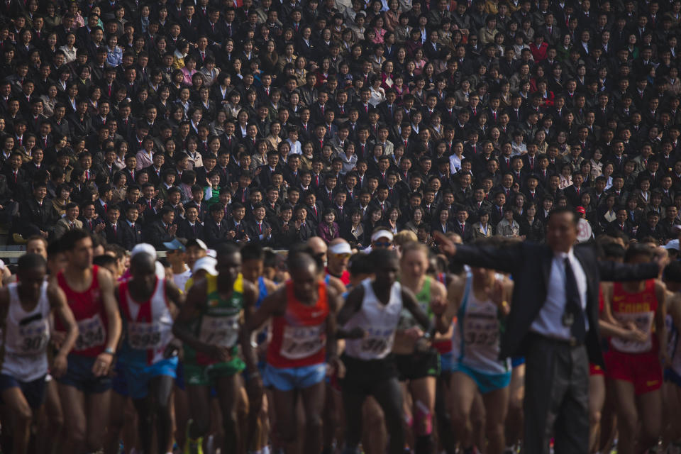 10ThingstoSeeSports - North Korean spectators watch from the stands of Kim Il Sung Stadium as runners line up at the start of the Mangyongdae Prize International Marathon in Pyongyang, North Korea on Sunday, April 13, 2014. The annual race, which includes a full marathon, a half marathon, and a 10-kilometer run, was open to foreign tourists for the first time this year. (AP Photo/David Guttenfelder, File)